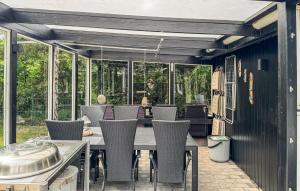 an outdoor dining room with a table and chairs at Lovely Home In Hemmet With Wifi in Hemmet +14 photos