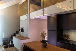 a dining room with a table and a ceiling at Ariel Penthouse - In the heart of Domodossola in Domodossola