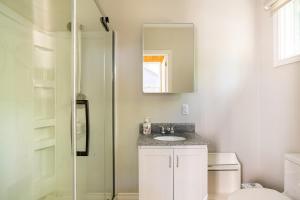 a bathroom with a toilet and a sink and a mirror at The Beach House - Steps To Beach Area 3 4br in Wasaga Beach +89 photos