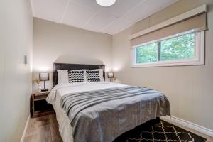 a bedroom with a large bed and a window at The Beach House - Steps To Beach Area 3 4br in Wasaga Beach