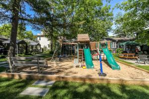 a playground in a park with a house at The Beach House - Steps To Beach Area 3 4br in Wasaga Beach