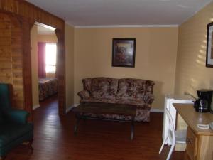 a living room with a couch and a table at Virden Motel in Virden