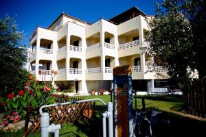 a white building with a lot of balconies at olivensun apartment 7 in Gythio