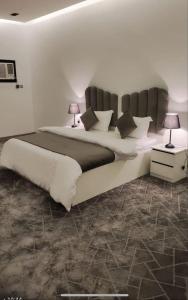 En eller flere senge i et værelse på تاج الخالدية للشقق المفروشه