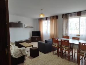 a living room with a table and a couch at Vivienda 2 sin ascensor in Laxe