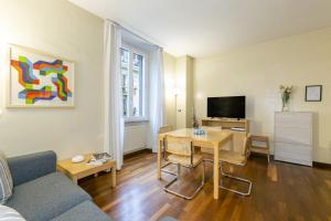 a living room with a couch and a table and a television at Rome Central Suite via Porcari in Rome