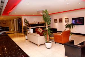 a lobby with couches and potted plants at فيا للشقق المخدومة in Al Khobar
