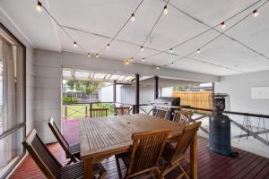 una sala da pranzo con tavolo e sedie in legno di Inverloch Dual Retreat with Spa Bath 400m to Beach a Inverloch
