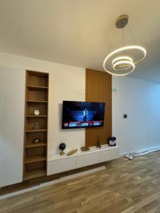 a living room with a flat screen tv on a wall at Lux stan in Bar
