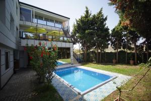 a house with a swimming pool next to a building at MDE Loisir Tanjis m in Tangier