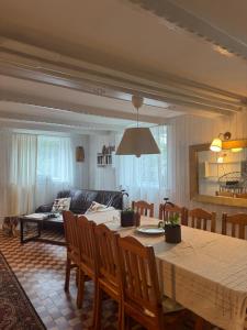 a living room with a table and a couch at Cisza pod Tatrami in Bukowina Tatrzańska