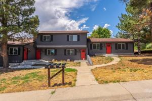 a house with red doors and a sign in front of it at Modern Arvada Duplex Close to Denver and Old Town in Arvada