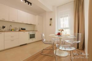 a kitchen with a table and chairs in a room at Sunset Da-Ra - Studio DeLuxe with Free Underground parking - by FullViewTour in Timişoara