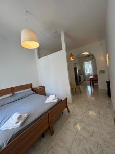a bedroom with a bed and a living room at Green Appartament in Marina di Camerota
