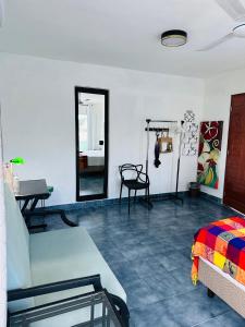 a room with a couch and a table and a mirror at The Quetzal in Cancún