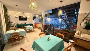 a restaurant with tables and chairs and a staircase at Pousada Santos in Parintins