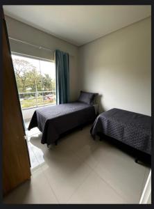 Postel nebo postele na pokoji v ubytování Residencial Violetas