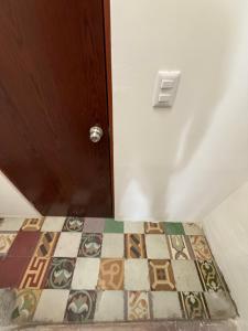 a room with a door with a tile floor at Camilos Suites in Querétaro