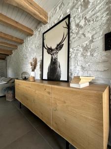 a picture of a deer on a wall at CottageChristine in Vaux-sur-Sûre