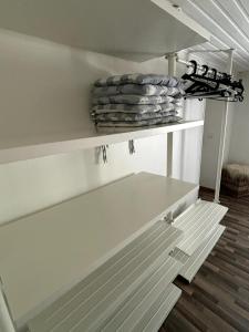 a white shelf with plates on it in a room at CottageChristine in Vaux-sur-Sûre +20 photos