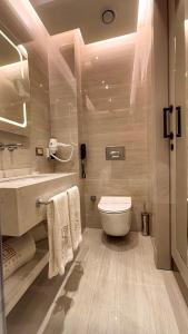 a bathroom with a toilet and a sink at Saygın Hotel Beşiktaş in Istanbul