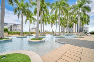 a pool with palm trees in a resort at 2 Bedroom OR King Studio Suites Four Seasons Hotel Miami Free Wi-Fi & Free Parking in Miami +94 photos