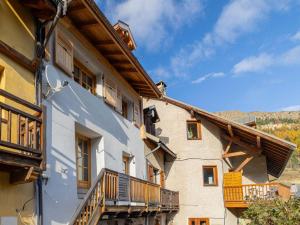 a building with balconies on the side of it at Maison rénovée familiale au village - FR-1-808-19 in Le Monêtier-les-Bains