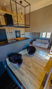a living room with two chairs and a couch at Suite Posillipo 298 in Naples
