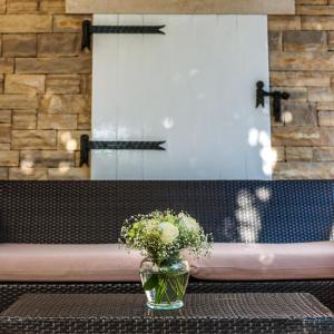 a vase of flowers sitting on a table in front of a mirror at Illustrious Brac Villa 6 Bedrooms Villa Bol Waterfront Private Pool & Balcony With Beautiful Views Bol in Bol