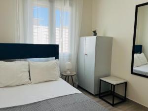 a bedroom with a bed and a mirror and a dresser at Seagull House Thassos island in Skala Kallirachis