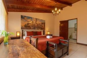 a bedroom with a bed and a dining room table at Ole España in Guatemala +55 photos