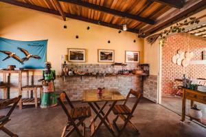 a dining room with a table and chairs in a room at Pousada Sertão in Alto Paraíso de Goiás