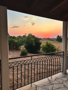 a view of a sunset from a balcony at Rest & Relax holiday house in Katakolo in Katakolon