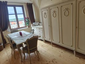 a dining room with a table and some cabinets at Residence Spillenberg Honeymoon Suite - Svadobna cesta in Levoča