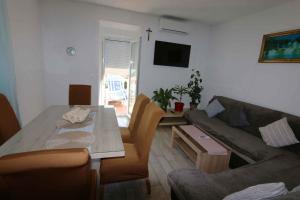 a living room with a couch and a table at Apartment in Silo - Insel Krk 13554 in Šilo
