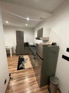 a kitchen with a stainless steel refrigerator in a room at Le fayet in La Celle-sous-Gouzon