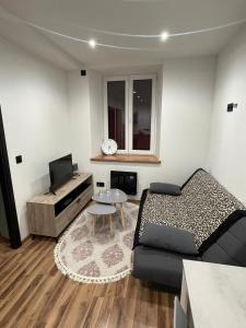 a small living room with a bed and a table at Le fayet in La Celle-sous-Gouzon