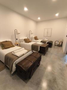 a room with three beds in a room at VILLA Bléanah in Santo Aleixo