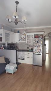 a kitchen with white cabinets and a refrigerator at A casa di Alessia in Santa Maria delle Mole