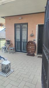 a patio with a bench and a chair next to a building at A casa di Alessia in Santa Maria delle Mole +35 photos