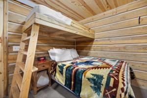 Un dormitorio con una litera en una cabaña de madera. en Black Hills Trailside Park Resort, en Hill City