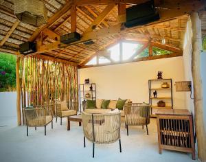 a patio with a couch and chairs and a table at CHEZ ALAIN in Toliara
