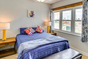 a bedroom with a blue bed and a window at Swim, Fish and Suntan Cozy Corpus Christi Retreat in Corpus Christi +16 photos