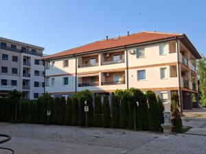 a building with a fence in front of a building at Apartman Jasmin in Bukorovac +4 photos