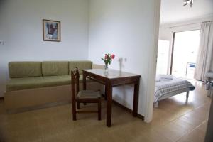 a living room with a table and a couch at olivensun apartment 8 in Gythio