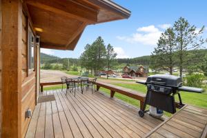 a grill on the deck of a house at Black Hills Trailside Park Resort in Hill City