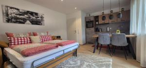 a room with a couch and a kitchen with a table at Renatas Ferienwohnung Maria in Sasbachwalden