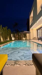 a swimming pool in a building at night at Villa Talya in Marrakech