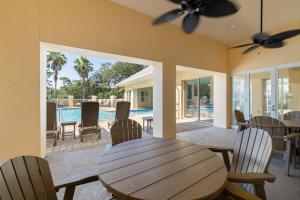 a dining room with a table and chairs and a pool at Martinique Vitamin Sea 10C in Gulf Highlands