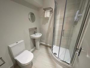 a bathroom with a shower and a toilet and a sink at CoStays Aparthotel - Middlesbrough in Middlesbrough